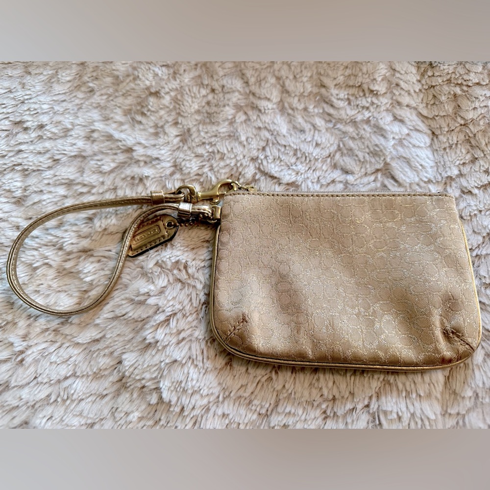 Coach leather wristlet; gold/champagne; perfect condition; lavender lining